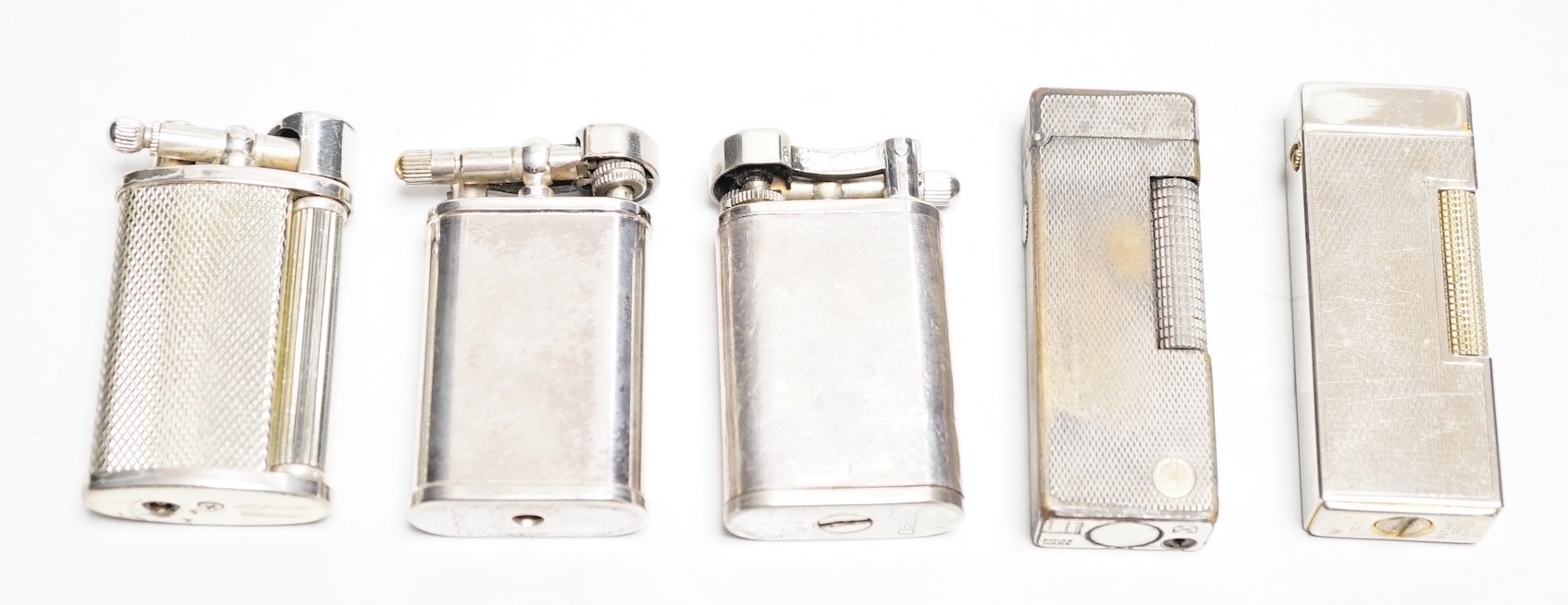 A Dunhill Rollegas lighter and four others